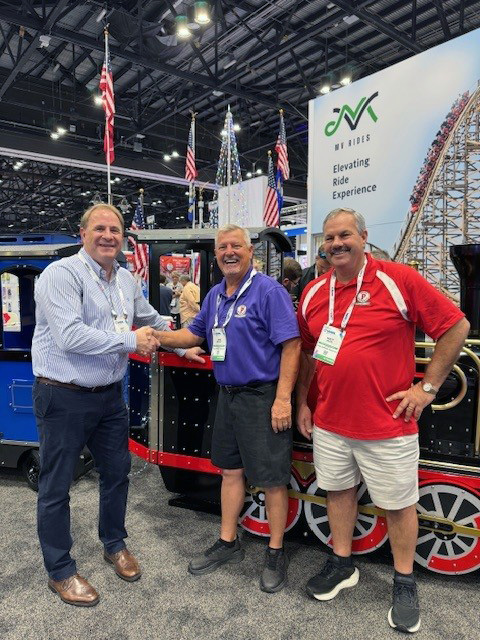 Sales interaction at IAAPA Expo 2025 with Wattman display train and clients