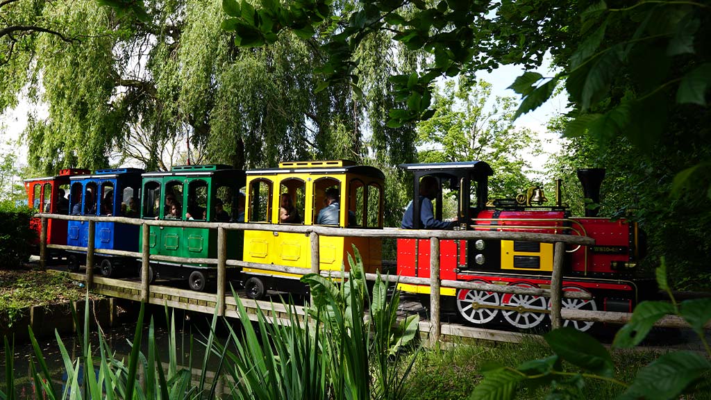 Trackless Wattman train operating in a US amusement park with excited riders