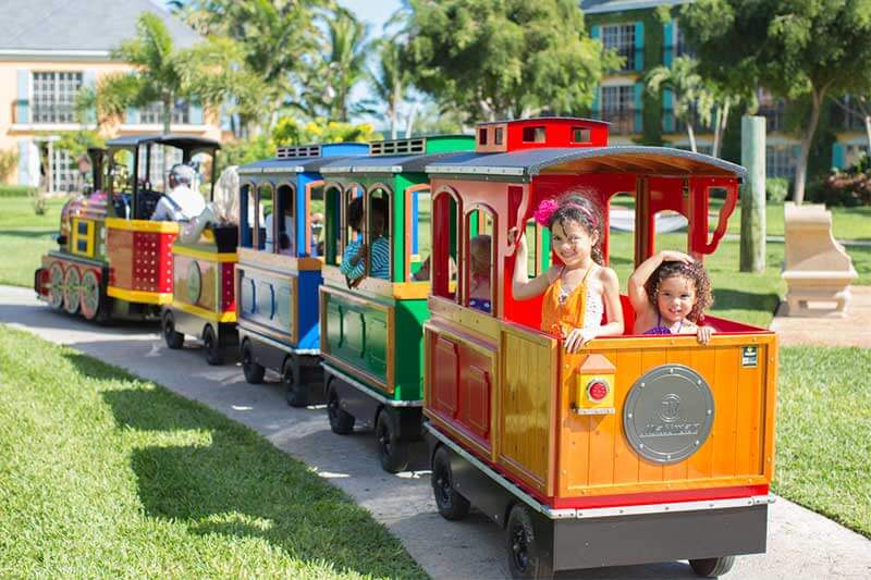Wattman electric trackless train operating at a U.S. resort property with guests aboard