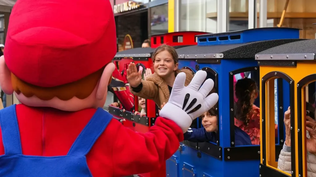 Wattman Maxi Express trackless train at a U.S. shopping mall — passengers including children enjoying the ride